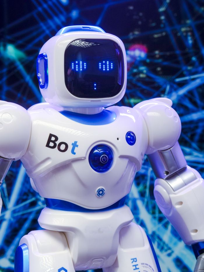 A humanoid robot with advanced blue LED eyes and sleek white design.